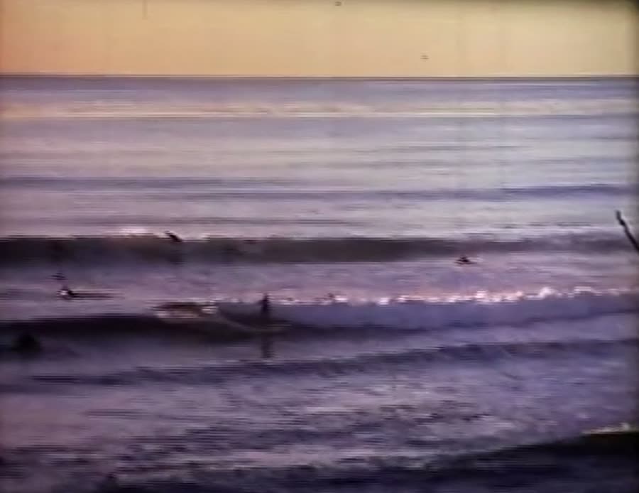 Surfers waiting in the lineup on a warm evening